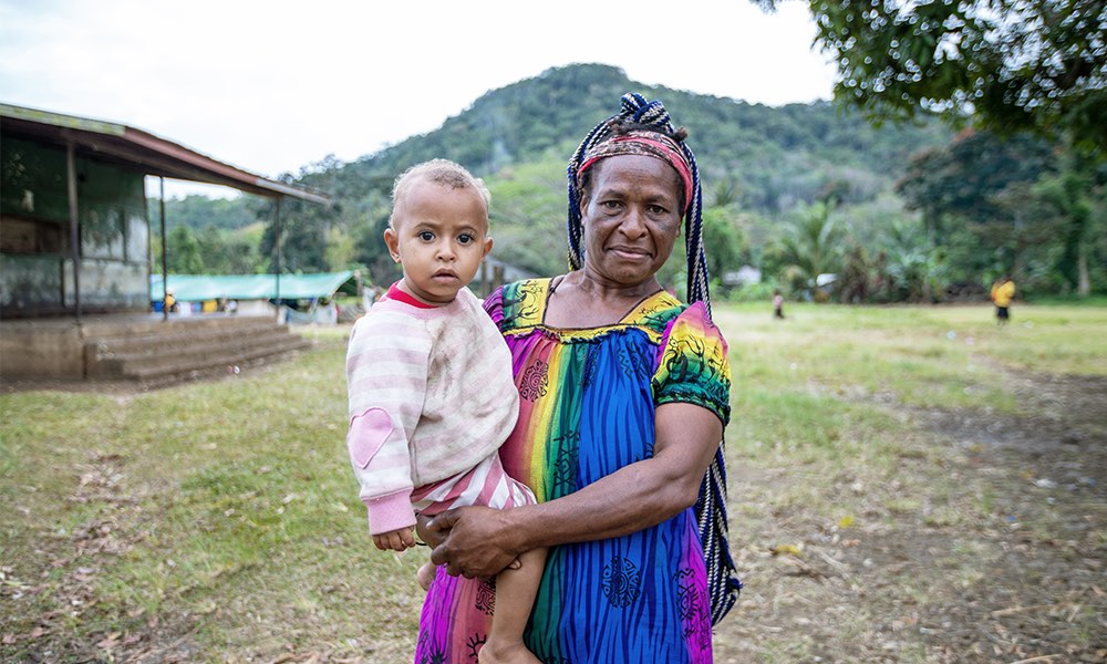 islander mother and child in village