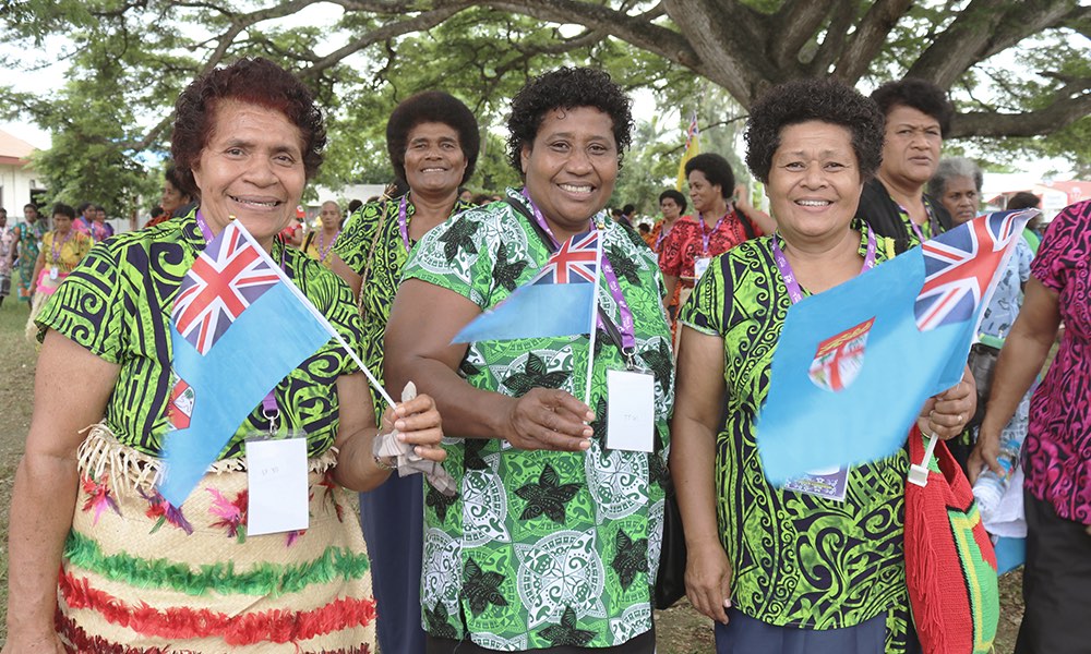 fijian women waving flags